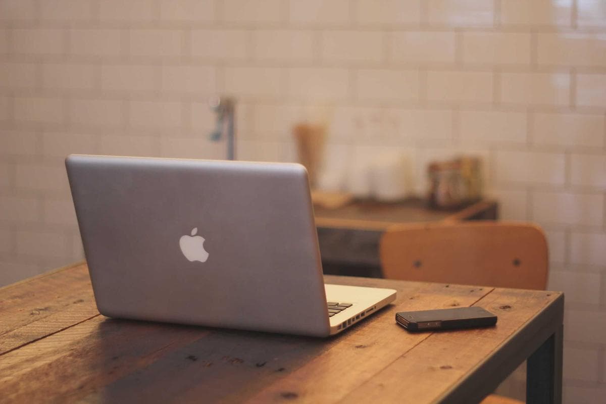 Placeholder photograph of a laptop on a table in a café.
