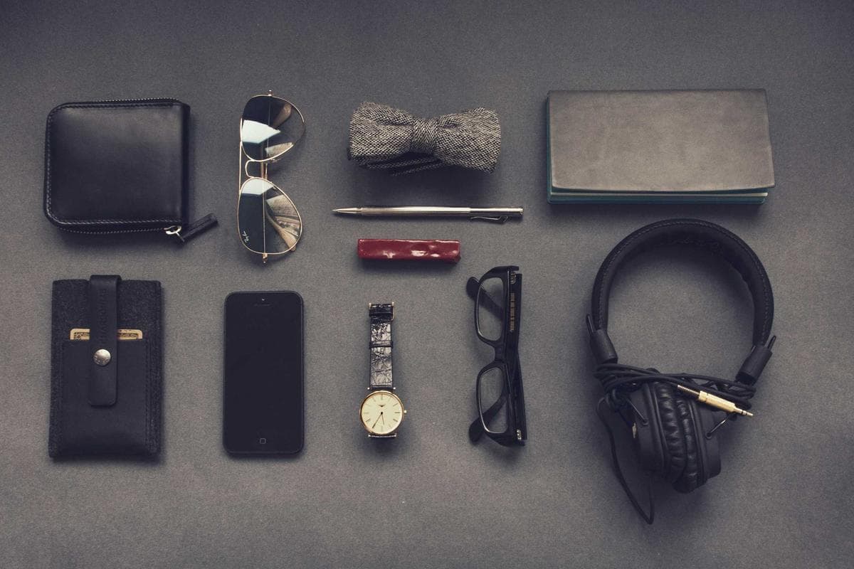 Placeholder photograph of everyday carry items arranged on a dark surface.